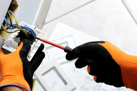 Electrician fixing plug socket wiring