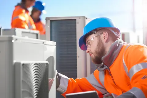 An electrician working in a roof